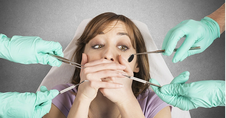 Woman with dental anxiety and fear resisting dentists