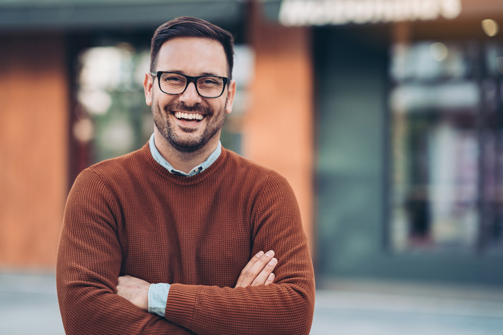 Confident man in glasses smiling brightly